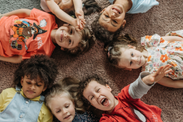 kids-lying-down-on-a-rug-in-a-circle